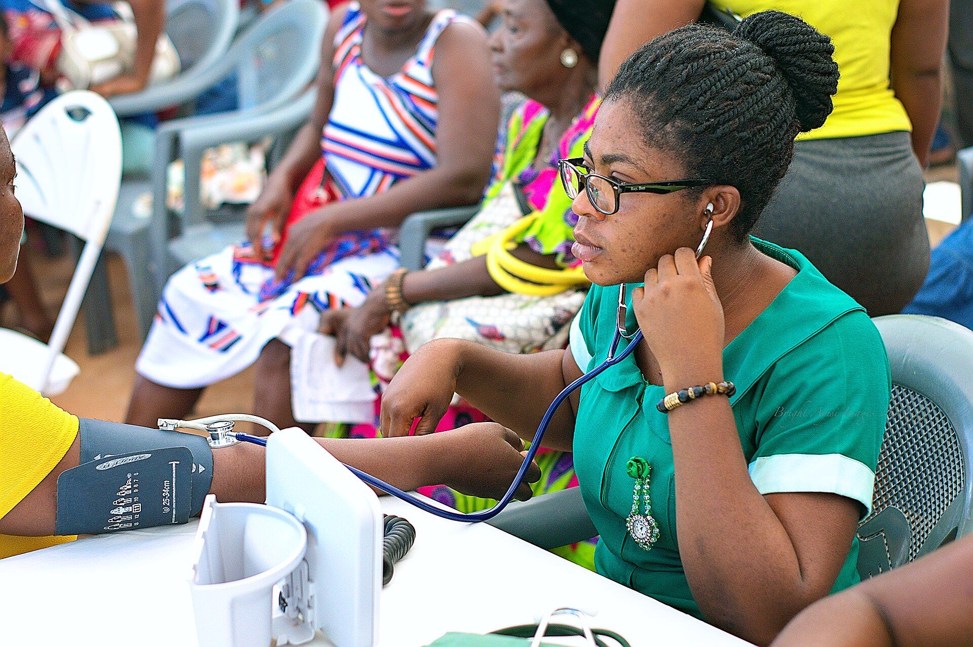 A nurse takes blood pressure at a community screening